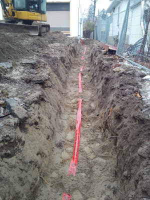 Secondary trench with 12 inches of sand and caution tape